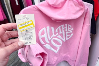 hand holding a clearance tag from a women's graphic hoodie at target