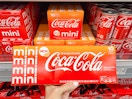 hand holding coca-cola orange cream soda in walmart beverage aisle