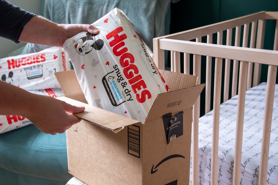 A pack of Huggies diapers being pulled from an Amazon box.