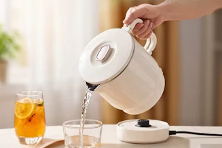 Lifestyle image of an electric kettle being used to pour water