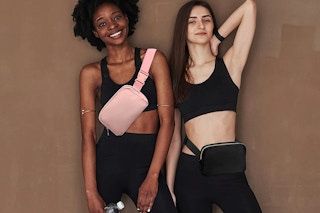 Two women wearing belt bags