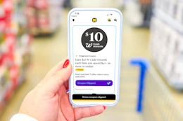 hand holding a smartphone displaying a 1-clip coupon in the KCL app