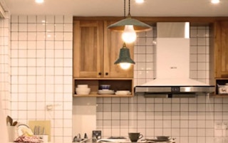 a kitchen with two light bulb hanging lights