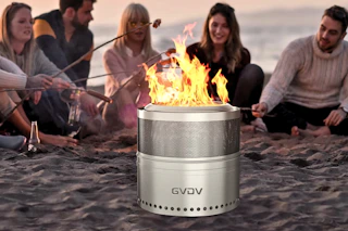 Lifestyle image of a group of friends at the beach roasting marshmallows around the fire