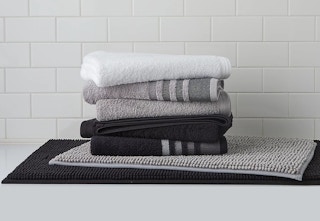 A stack of white, gray, and black towels