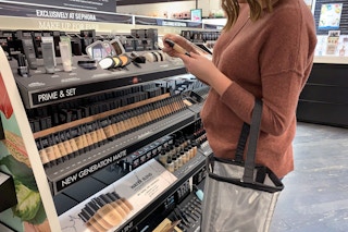 Woman looking at makeup in Sephora.