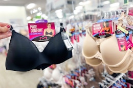 a hand holding up a black bra