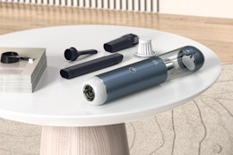 Minthouz Car Vacuum sitting on an accent table.