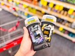 hand holding axe premium stick deodorants in cvs