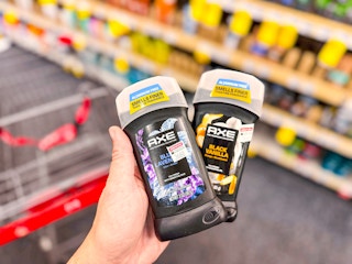 hand holding axe premium stick deodorants in cvs
