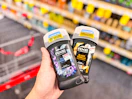 hand holding axe premium stick deodorants in cvs