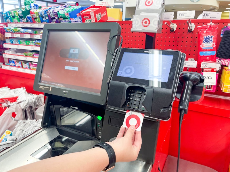 a person using a target red card at self checkout at target