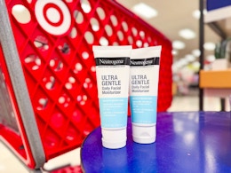 2 neutrogena moisturizers sitting on a table in front of a target cart