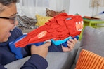 Kid holding the  NERF Wild Lionfury, Easy Play Dart Blaster.