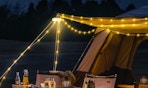 string lights over a campsite 
