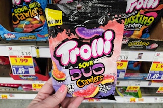 hand holding a bag of trolli gummy candy at kroger