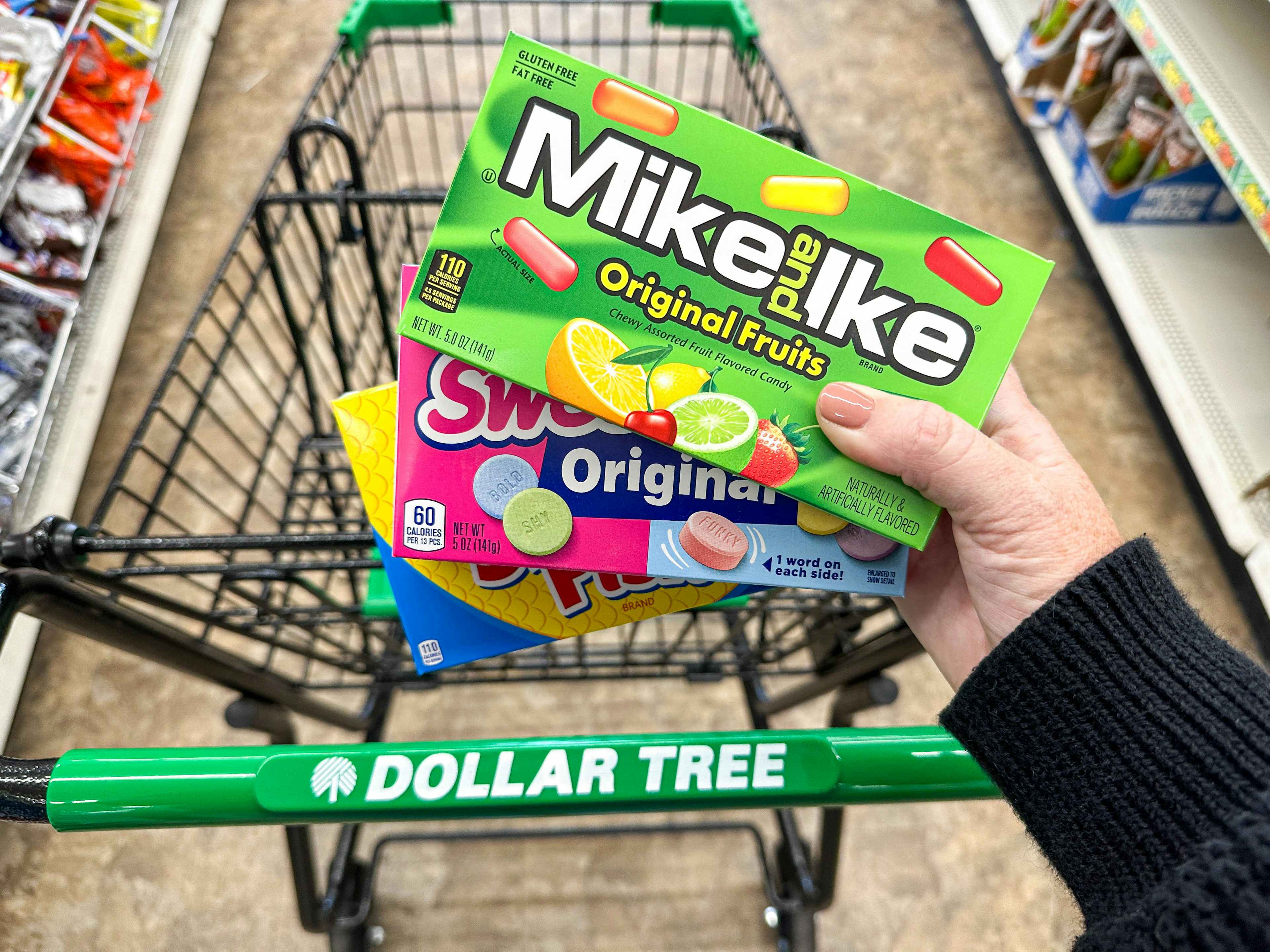 a person holding dollar tree candy 