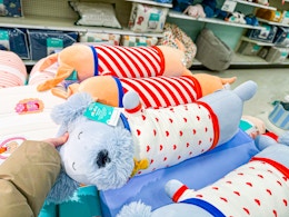 pillowfort weighted plush pillows sitting on a target shelf