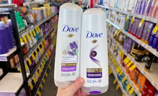 hand holding two bottles of dove hair care