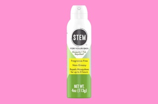 a can of bug spray on a pink background