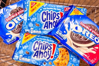nabisco chips ahoy and oreo cookies piled together in a cart
