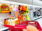 target cart parked in front of halloween costumes sitting on a shelf