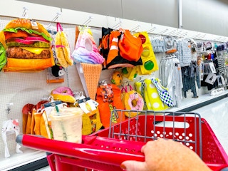 target cart parked in front of halloween costumes sitting on a shelf