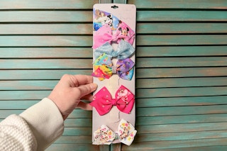someone holding up a set of bows with some missing