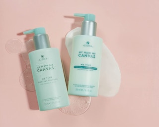 vegan conditioner in a mint green bottles on a pink background