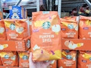 hand holding a bag of starbucks pumpkin spice coffee