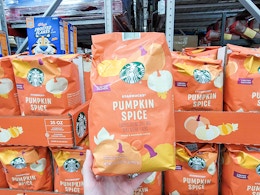 hand holding a bag of starbucks pumpkin spice coffee