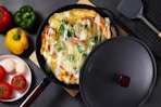 wok holding egg dish next to ingredients