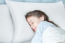 a girl sleeping on a pillow