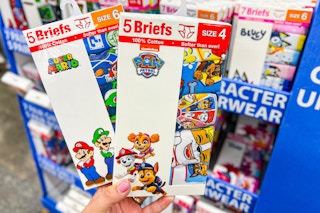 hand holding two packs of kids' underwear