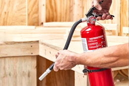 Lifestyle image of the First Alert Home Fire Extinguisher being used