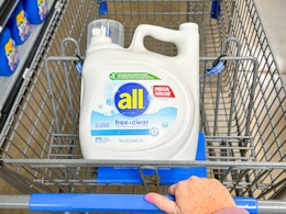 white bottle of all Free + Clear laundry detergent in a Walmart cart