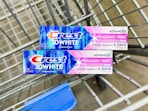 2 Crest 3D White Toothpastes in Walmart shopping cart (close up shot)