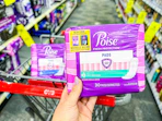 hand holding poise pads in cvs