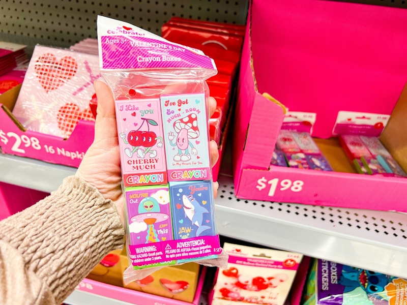 hand holding valentines day crayon boxes at walmart