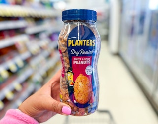 hand holding bottle of Planters peanuts