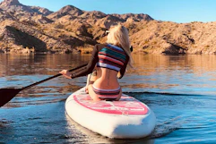 a woman on an inflatable paddleboard