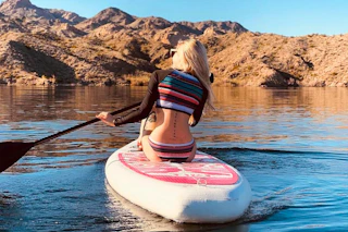 a woman on an inflatable paddleboard