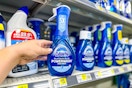 hand holding dawn powerwash dish spray next to store shelf