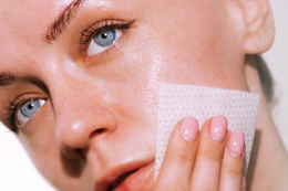 a woman using an exfoliating pad