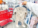 hand holding a cloud island sleep & play set at target