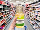hand holding wesson canola oil at walmart