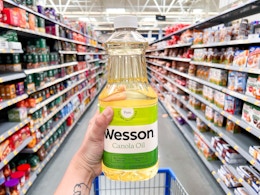 hand holding wesson canola oil at walmart