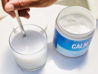 Calm magnesium powder in a glass of water with the container