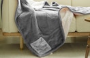 a grey heated blanket on a couch