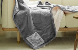 a grey heated blanket on a couch